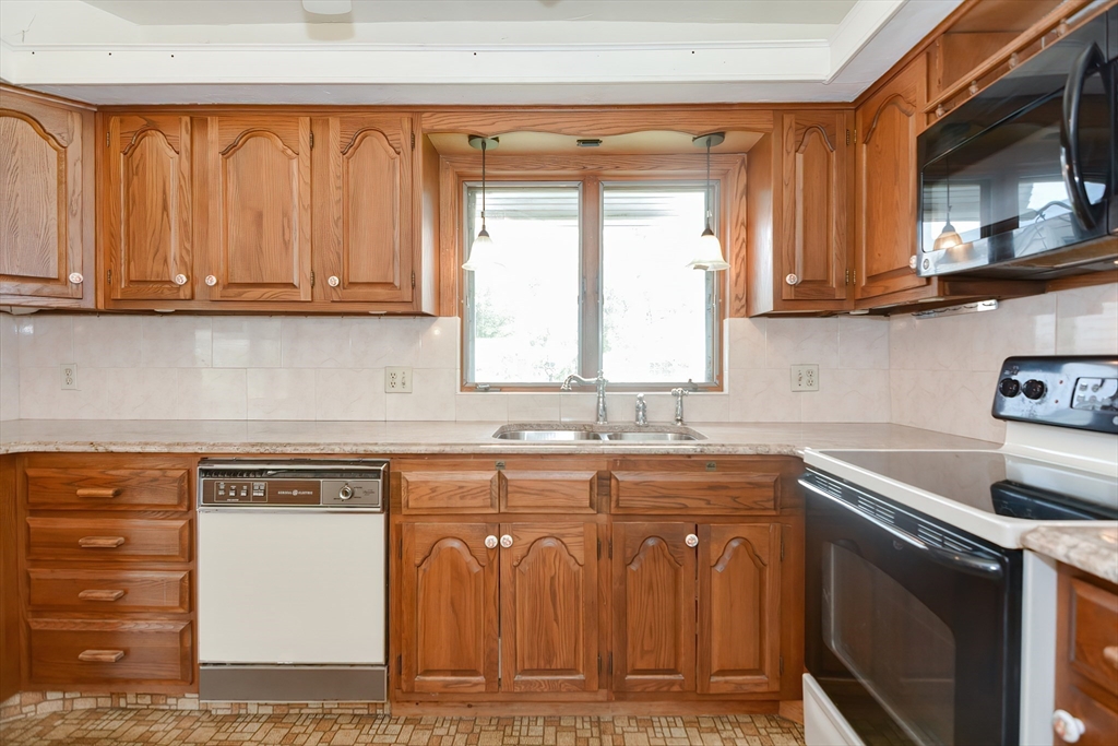 12 Catherine Road Framingham, MA 01701 - Photo 9 of 40 a kitchen with stainless steel appliances granite countertop a sink stove and cabinets