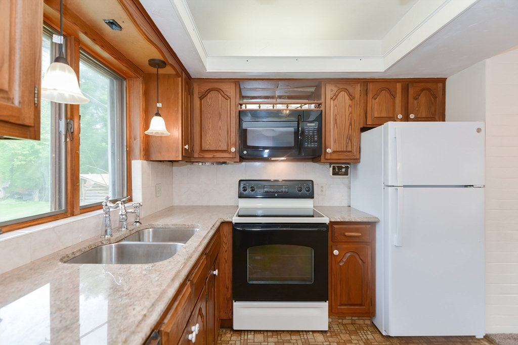 12 Catherine Road Framingham, MA 01701 - Photo 10 of 40 a kitchen with cabinets a refrigerator and a sink