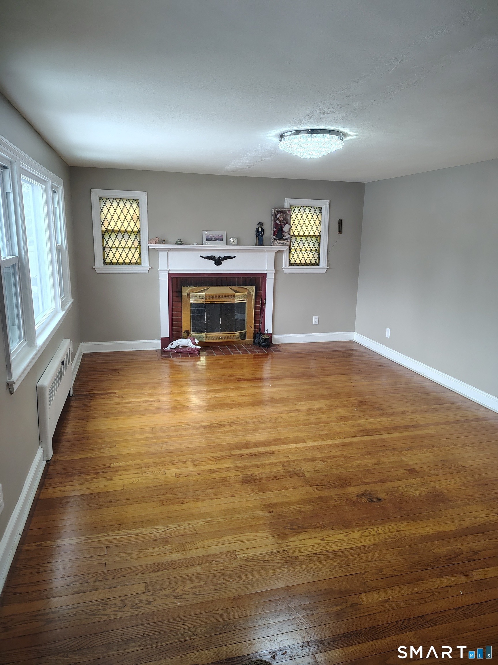 166 George Street Hartford, CT 06114 - Photo 2 of 29 a view of an empty room with a window and fireplace