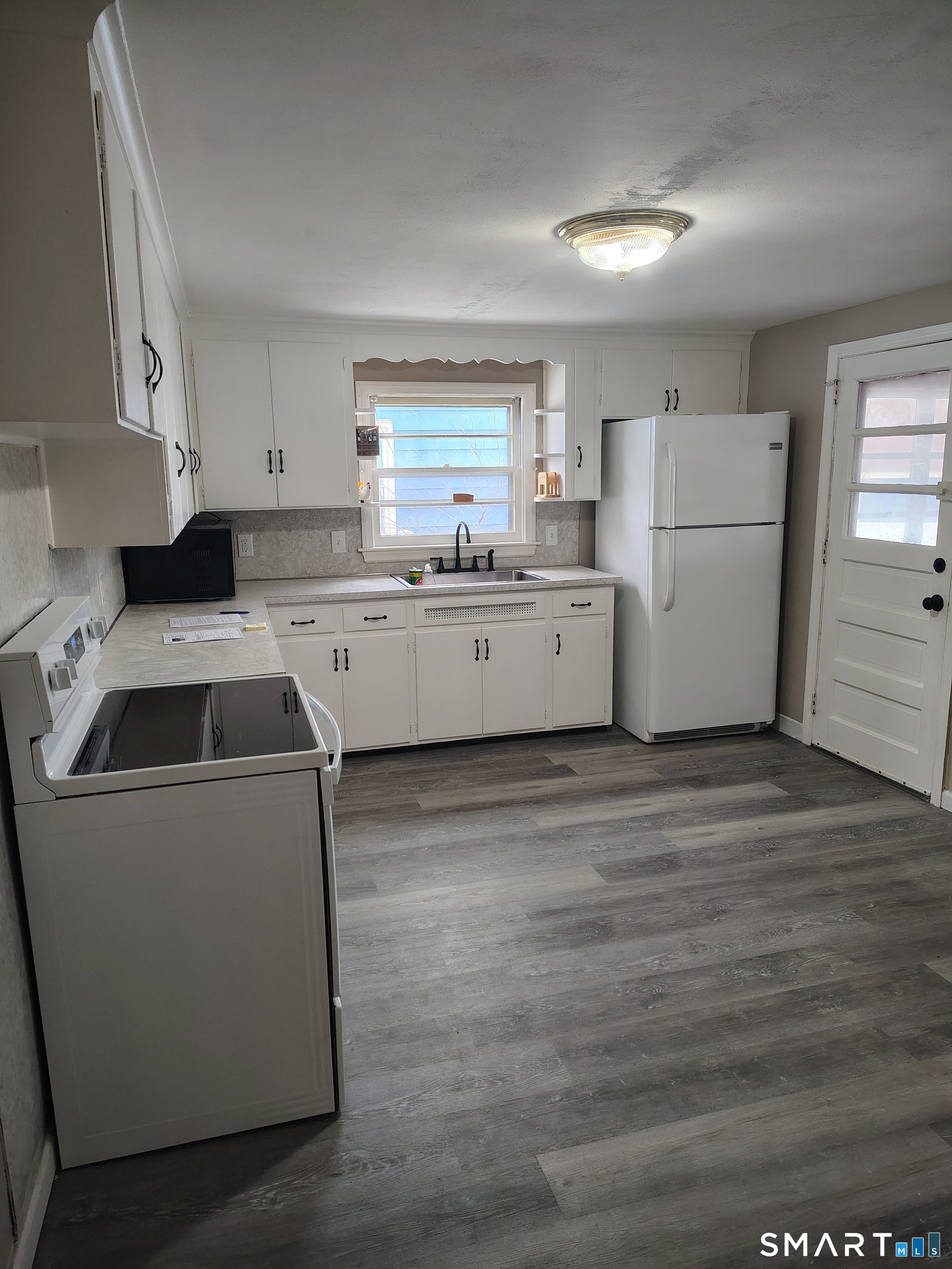 166 George Street Hartford, CT 06114 - Photo 3 of 29 a kitchen that has a sink and a stove in it