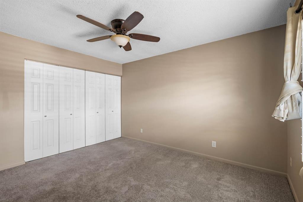 903 Buck Court Brandon, FL 33511 - Photo 20 of 24 an empty room with ceiling fan and window
