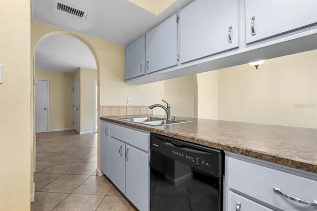 a kitchen with granite countertop a sink and cabinets
