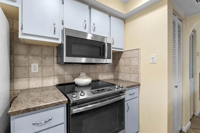 a kitchen with a stove and a microwave