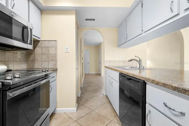 a kitchen with stainless steel appliances granite countertop a sink and a stove