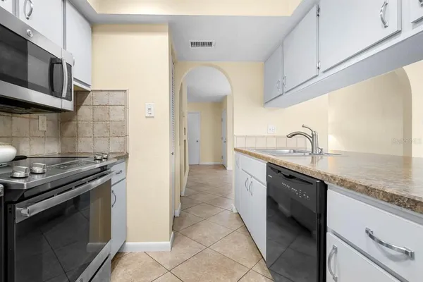 a kitchen with stainless steel appliances granite countertop a sink and a stove