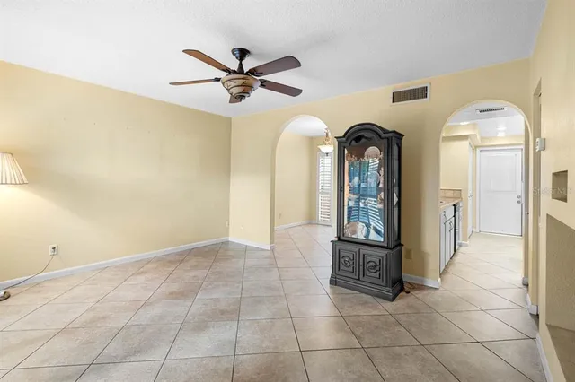 a view of a hallway with entryway mirror and a chandelier