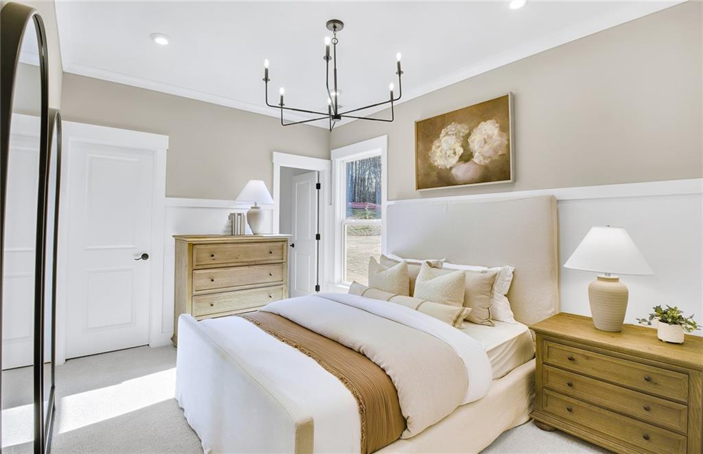 5375 Julep Court Cumming, GA 30028 - Photo 12 of 22 a bedroom with a bed and a chandelier