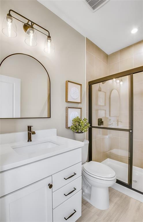 5375 Julep Court Cumming, GA 30028 - Photo 13 of 22 a bathroom with a toilet a sink and a mirror