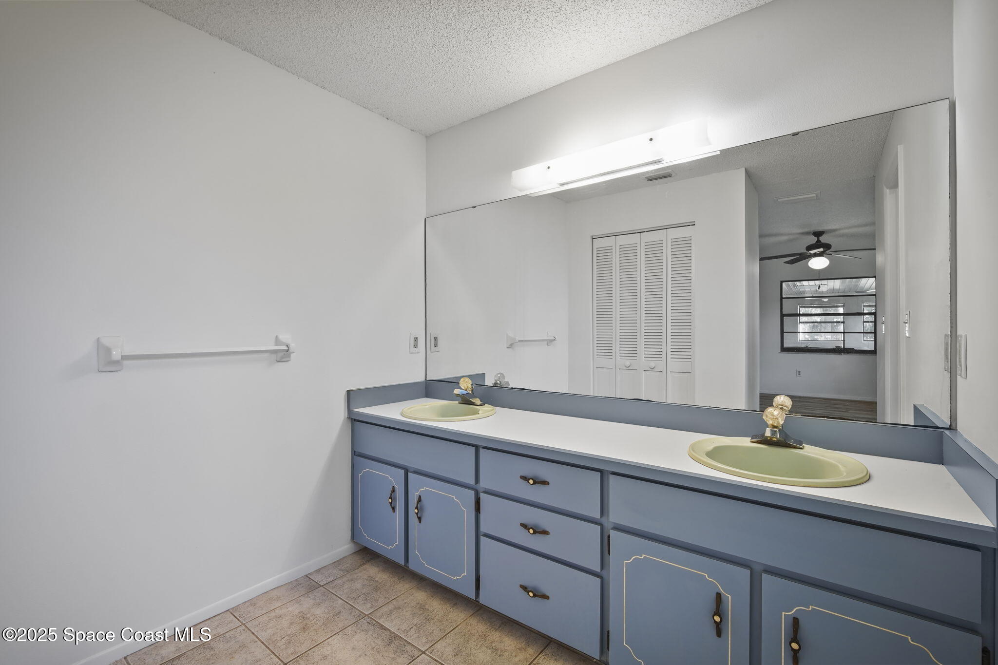 3125 Lionel Road Mims, FL 32754 - Photo 14 of 31 a bathroom with a granite countertop sink a mirror and double