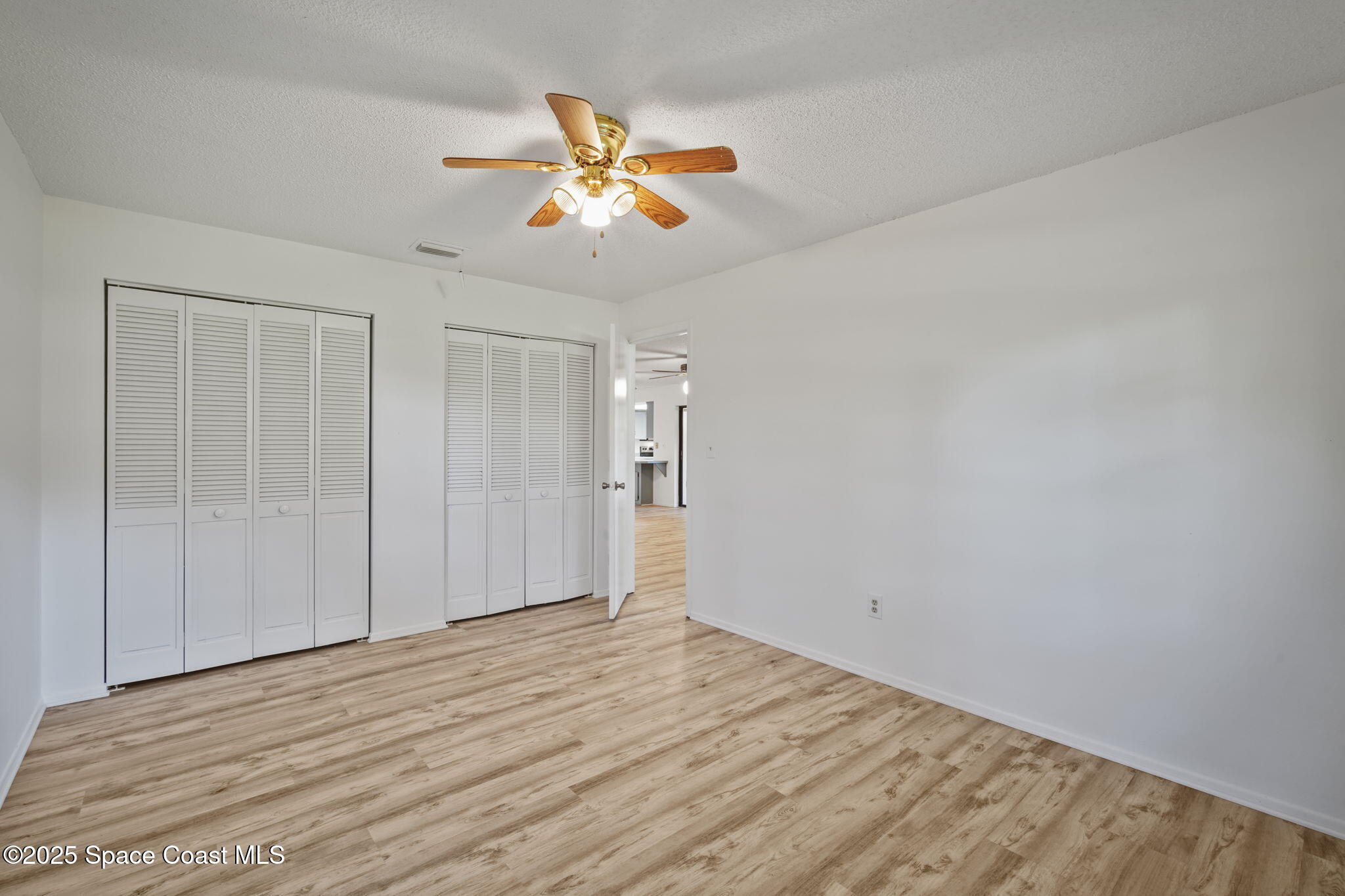 3125 Lionel Road Mims, FL 32754 - Photo 19 of 31 a view of an empty room with wooden floor