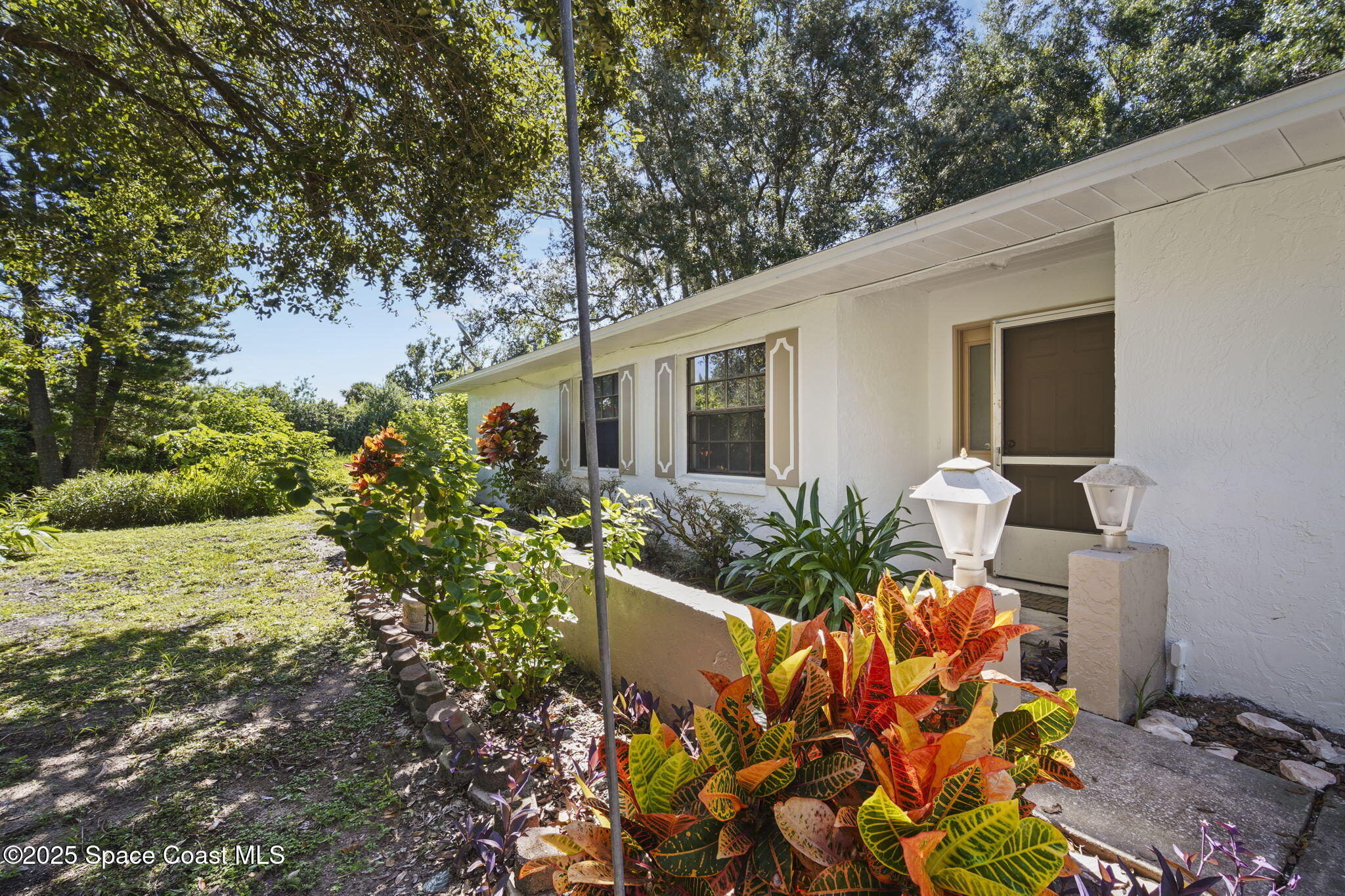 3125 Lionel Road Mims, FL 32754 - Photo 25 of 31 a front view of a house with a yard