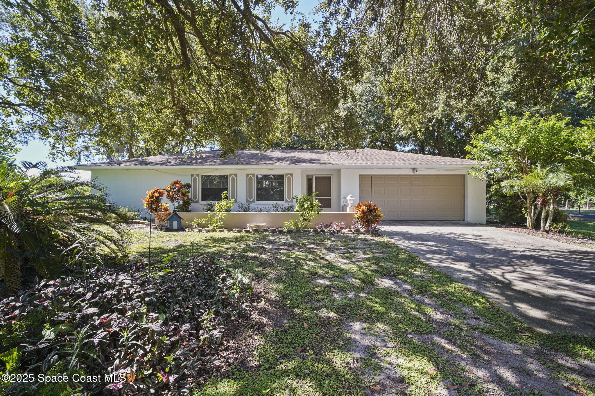 3125 Lionel Road Mims, FL 32754 - Photo 26 of 31 a view of a house with backyard sitting area and garden