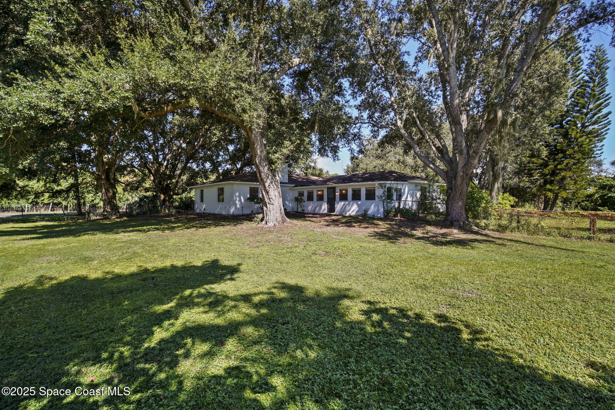 3125 Lionel Road Mims, FL 32754 - Photo 27 of 31 a view of house with garden space and trees