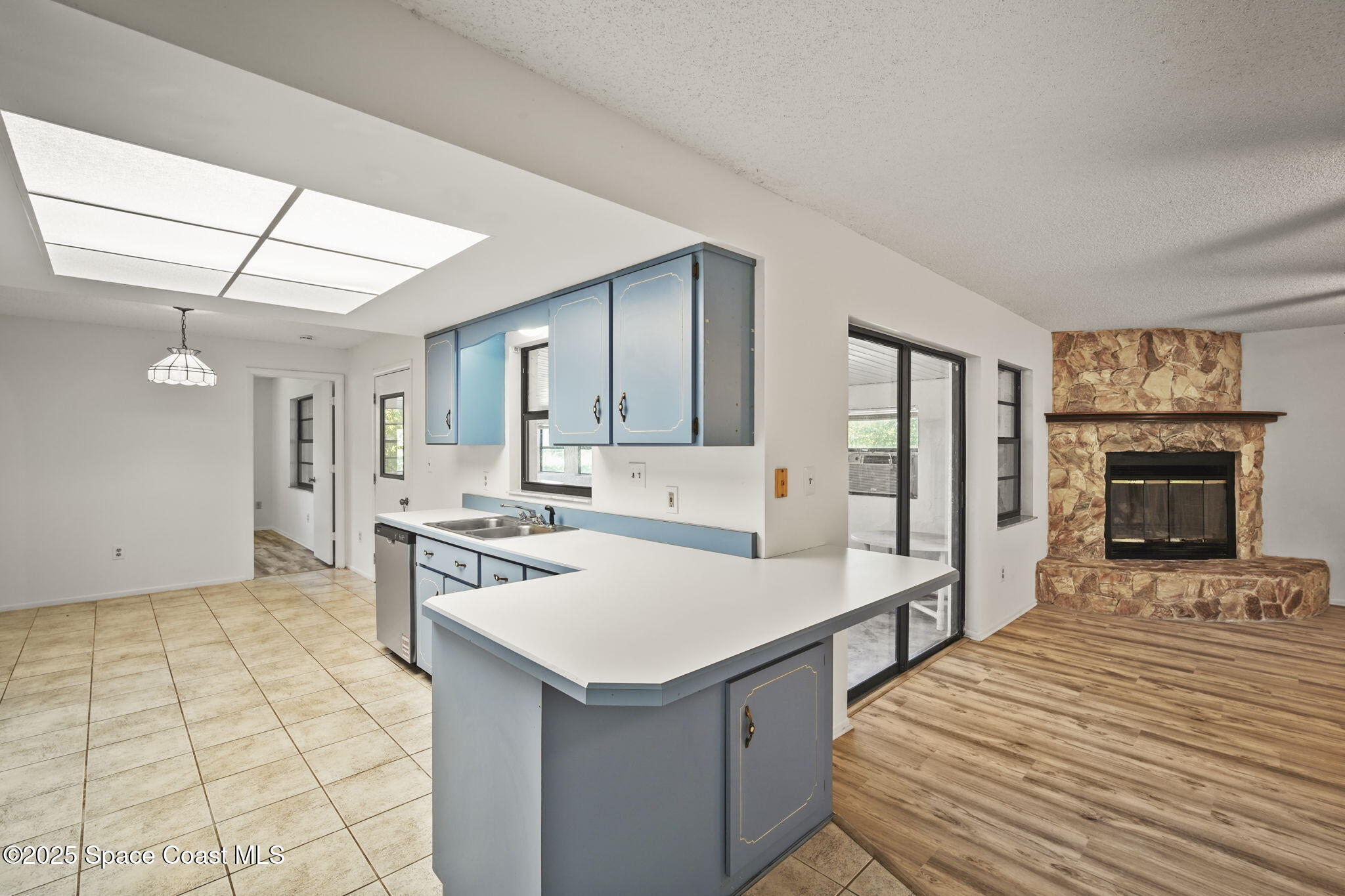 3125 Lionel Road Mims, FL 32754 - Photo 8 of 31 a large white kitchen with a stove a sink a microwave and dining table