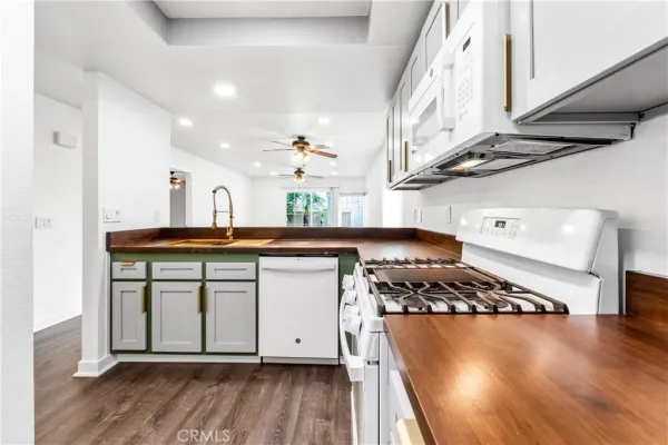 a kitchen with stainless steel appliances a sink a stove and cabinets