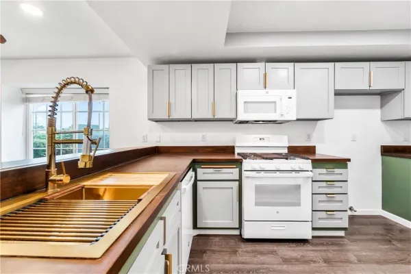 a kitchen with white cabinets and white appliances