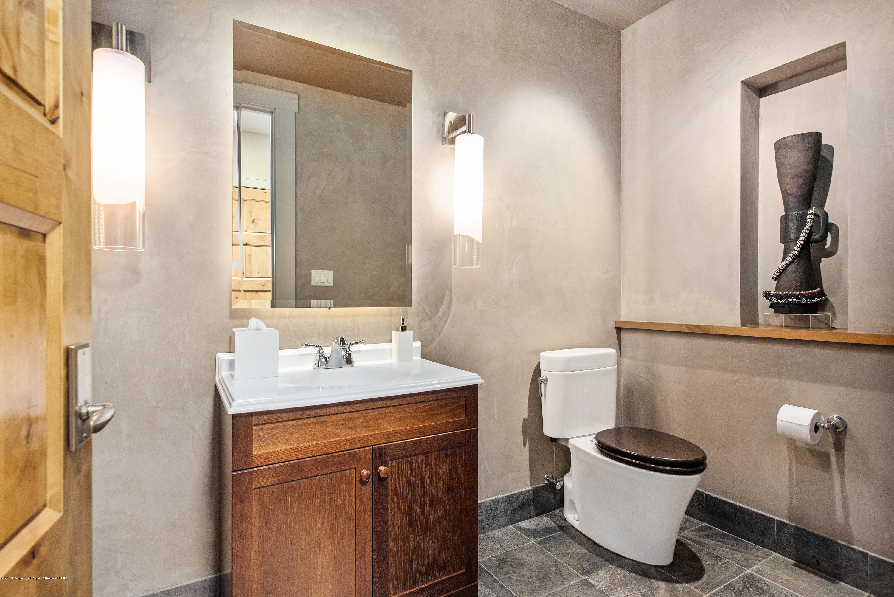 501 Rio Grande Place, Unit 205 Aspen, CO 81611 - Photo 12 of 17 a bathroom with a toilet sink and mirror