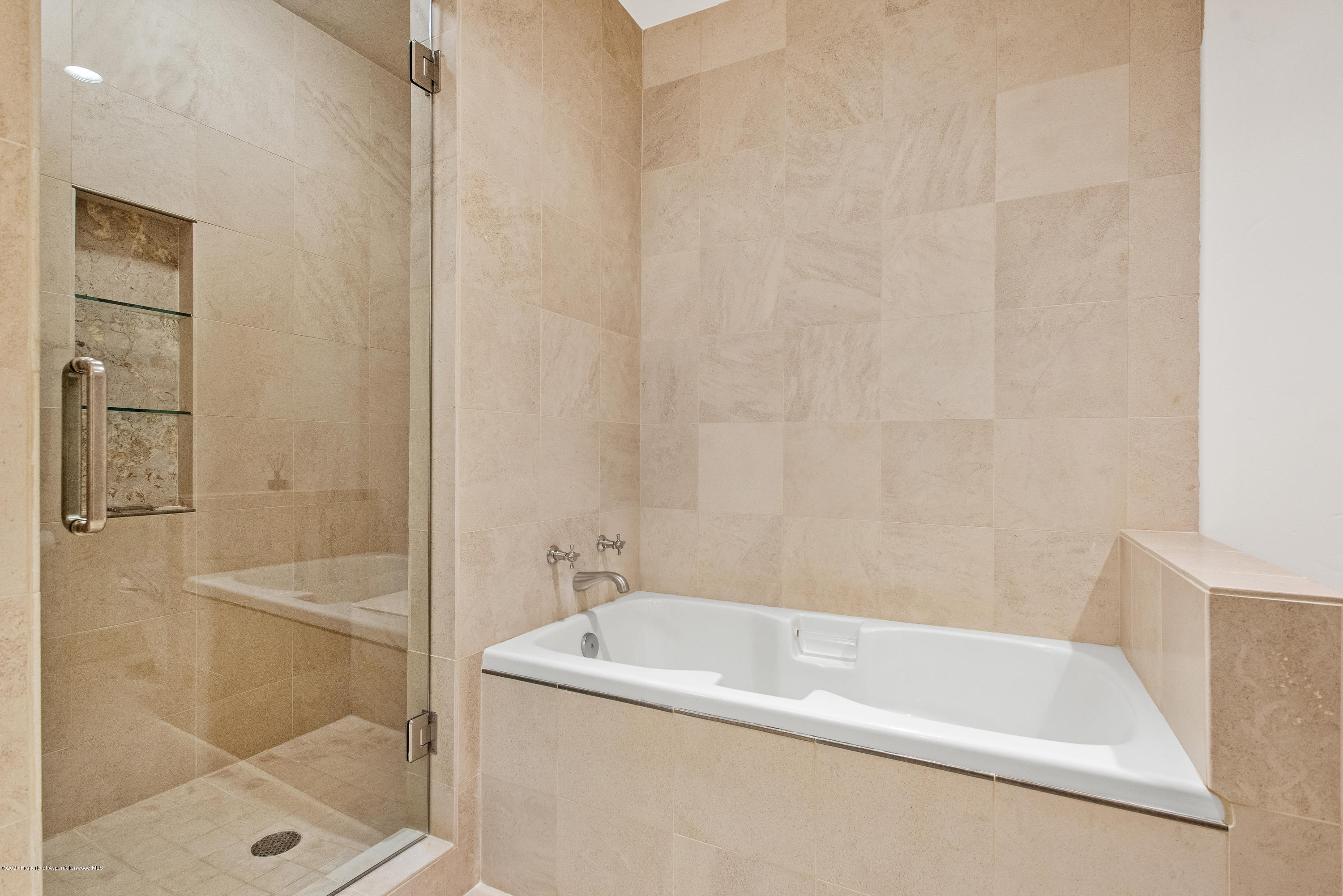 501 Rio Grande Place, Unit 205 Aspen, CO 81611 - Photo 14 of 17 a white bath tub sitting next to a white sink and vanity