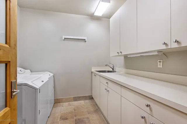 a utility room with sink dryer and washer