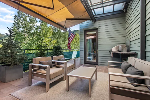 a view of a patio with a table and chairs