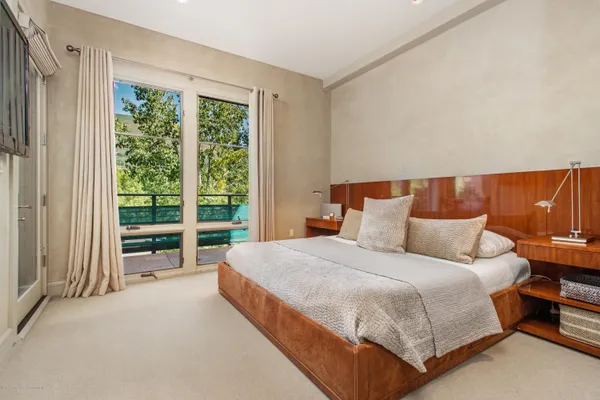 a bedroom with a bed and a large window