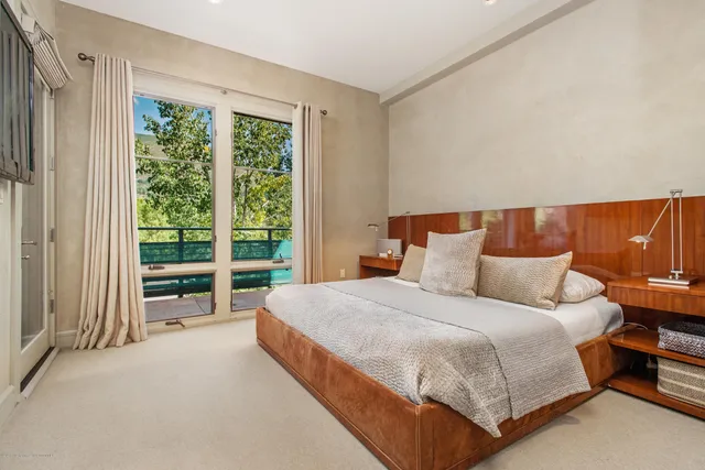 a bedroom with a bed and a large window