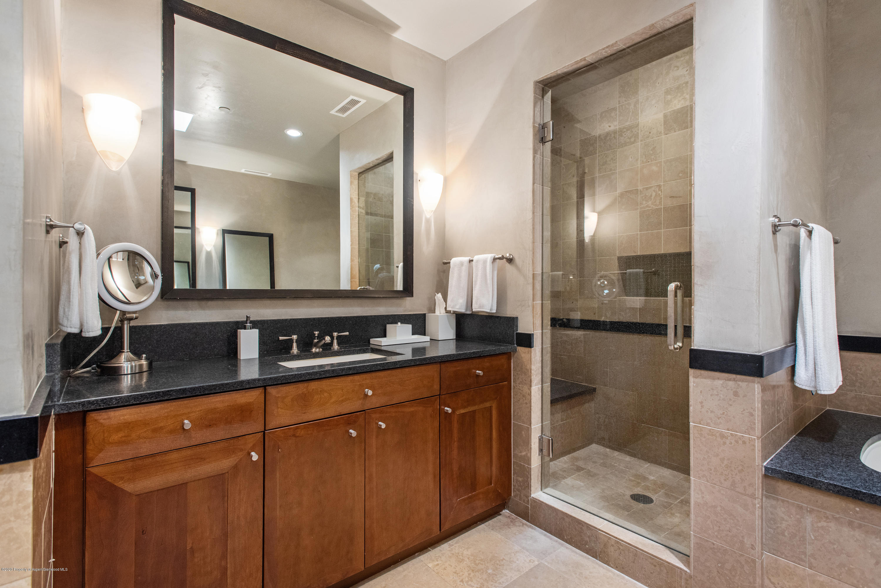 501 Rio Grande Place, Unit 205 Aspen, CO 81611 - Photo 10 of 17 a bathroom with a sink a mirror and a shower