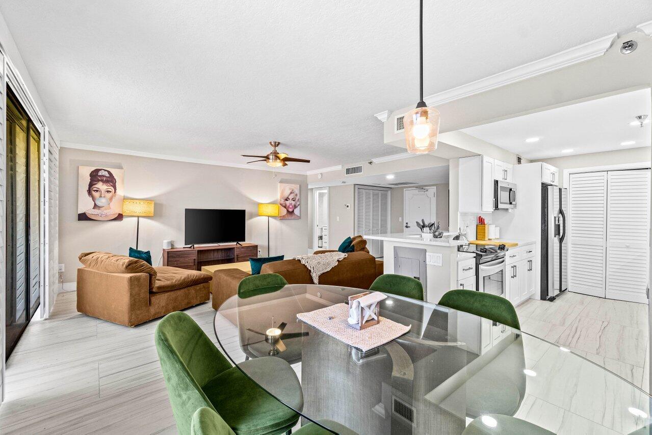 899 Jeffery Street, Unit 2120 Boca Raton, FL 33487 - Photo 2 of 38 a living room with furniture kitchen view and a flat screen tv