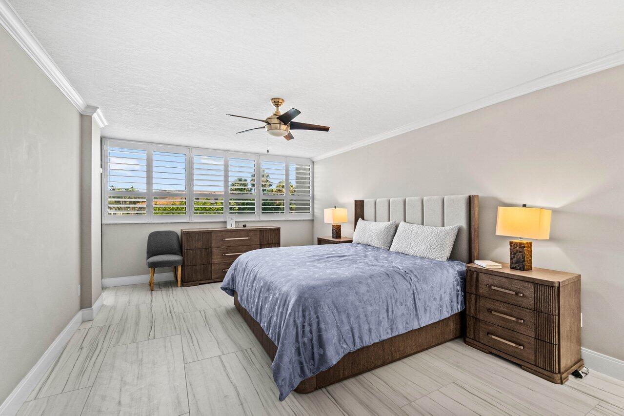 899 Jeffery Street, Unit 2120 Boca Raton, FL 33487 - Photo 21 of 38 a bedroom with a bed and large window