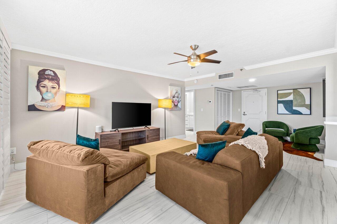 899 Jeffery Street, Unit 2120 Boca Raton, FL 33487 - Photo 3 of 38 a living room with furniture and a flat screen tv