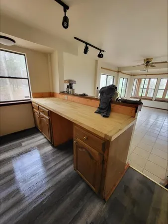 a kitchen with stainless steel appliances granite countertop a stove and a wooden floors