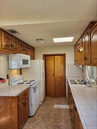 a kitchen with stainless steel appliances granite countertop a sink stove and cabinets