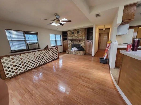 a very nice looking room with wooden floor and furniture
