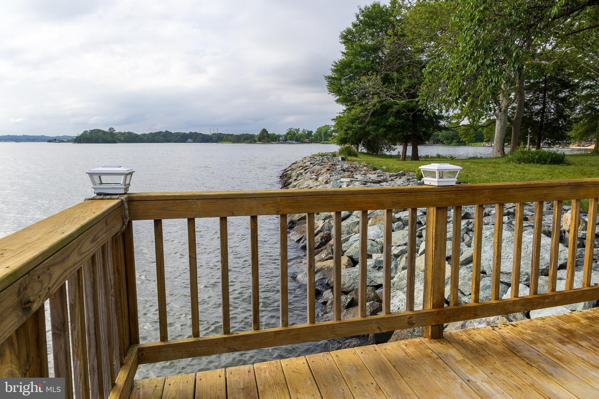 6225 Sandy Point Road Prince Frederick, MD 20678 - Photo 13 of 45 a view of wooden fence and lake
