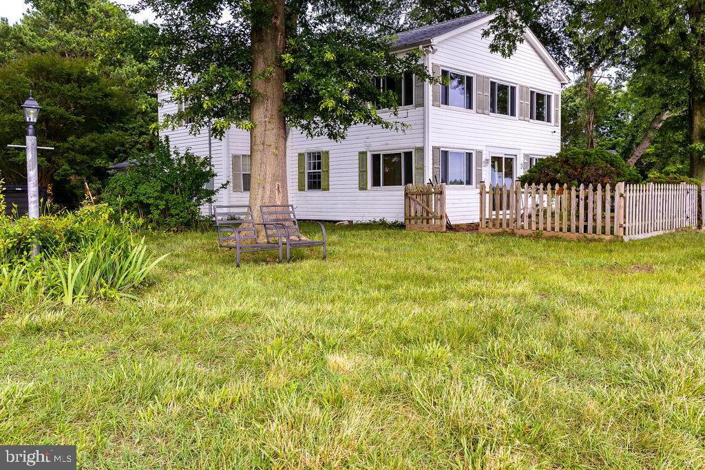 6225 Sandy Point Road Prince Frederick, MD 20678 - Photo 30 of 45 a front view of a house with a yard table and chairs
