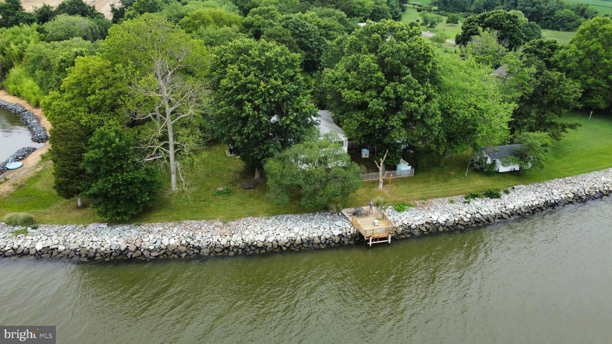 6225 Sandy Point Road Prince Frederick, MD 20678 - Photo 5 of 45 an aerial view of a house with a yard and lake view