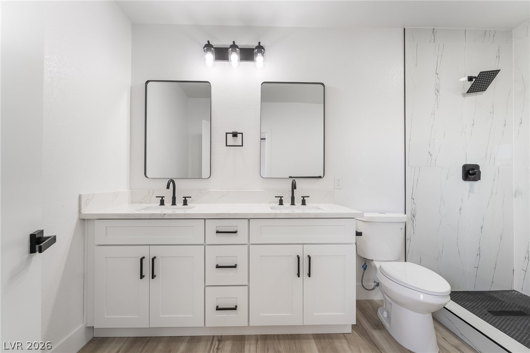 39 Lowery Street Henderson, NV 89015 - Photo 19 of 40 Dual vanities with sleek black hardware elevate this bright, contemporary bathroom.