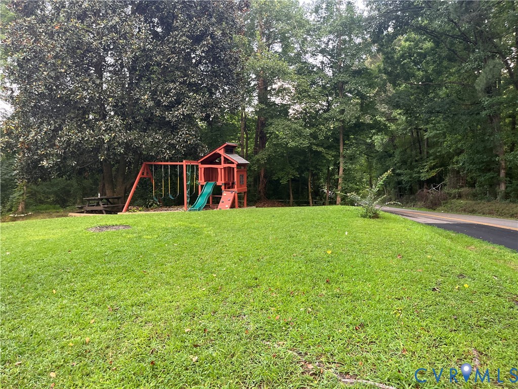 3074 Rocky Ford Road Crewe, VA 23930 - Photo 5 of 48 Expansive green lawn with mature trees and a paved