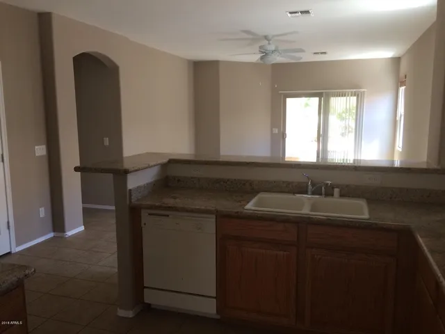 a kitchen with a sink and a mirror