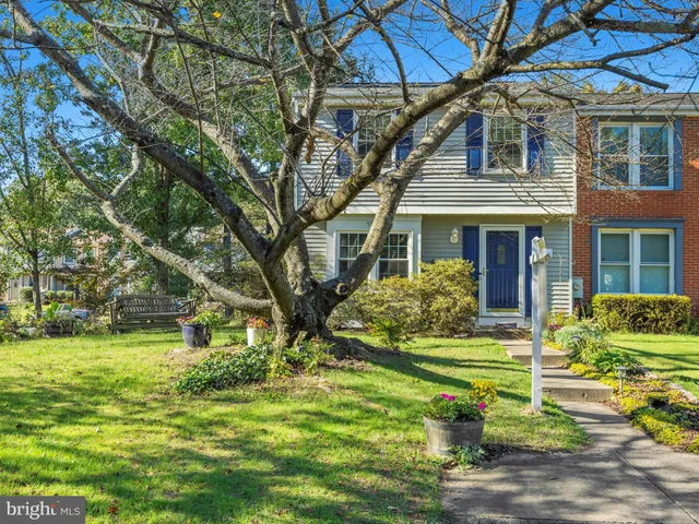 a front view of a house with a yard table and chairs