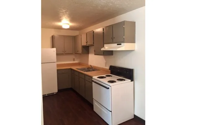 a kitchen with stainless steel appliances a white stove top oven and a refrigerator