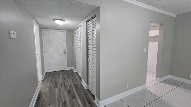 a view of hallway with wooden floor