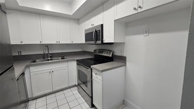 a kitchen with a sink and cabinets