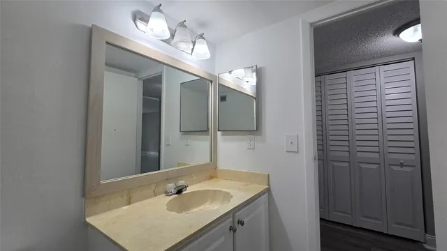 a bathroom with a sink vanity granite and a mirror