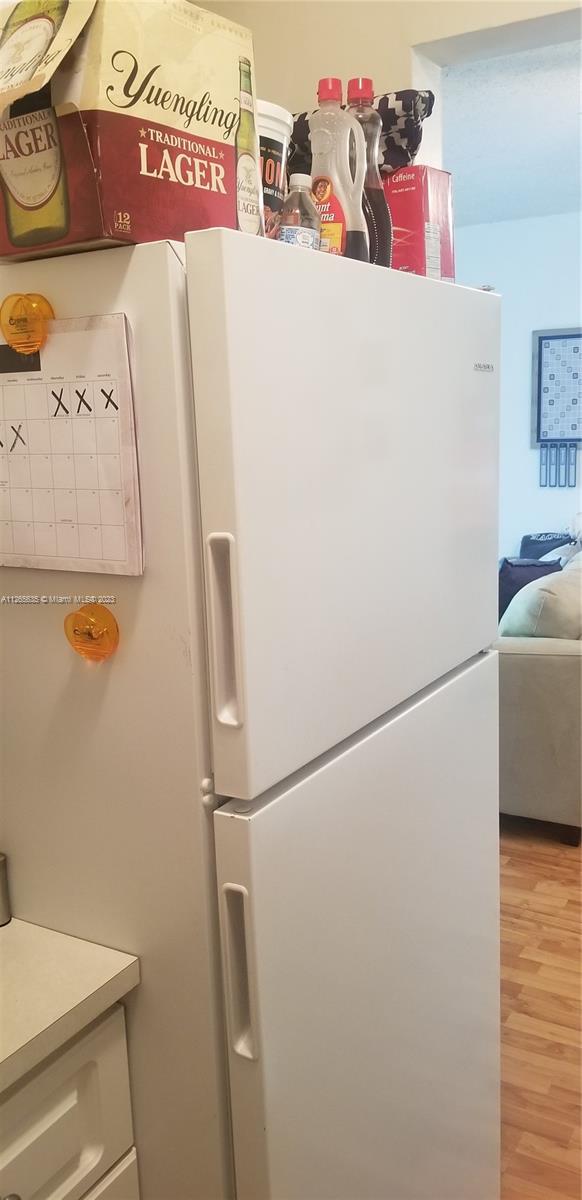 2920 Southwest 28th Terrace, Unit 304 Miami, FL 33133 - Photo 12 of 26 a white refrigerator freezer sitting inside of a kitchen