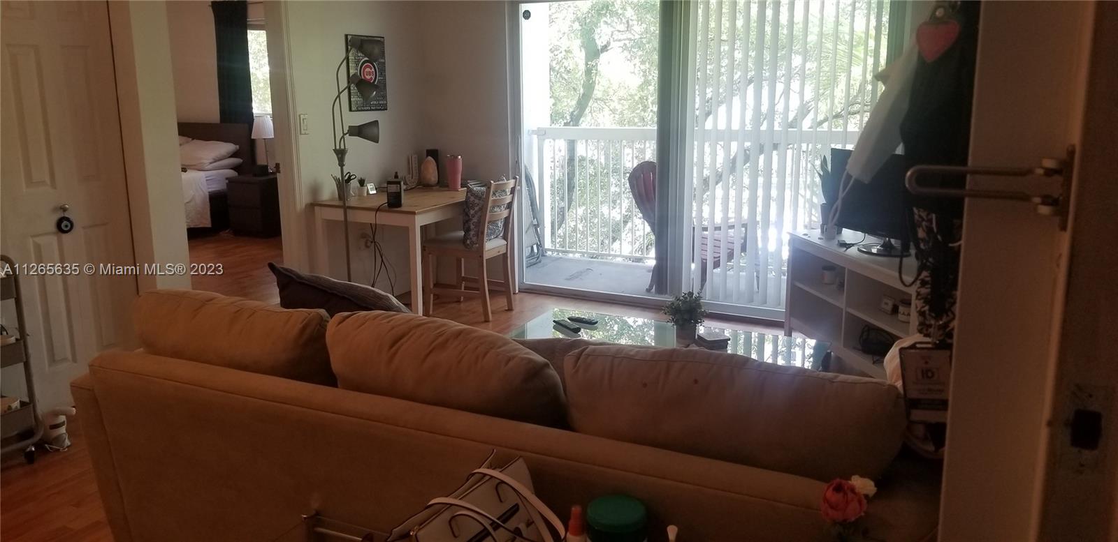 2920 Southwest 28th Terrace, Unit 304 Miami, FL 33133 - Photo 2 of 26 a living room with furniture and a floor to ceiling window