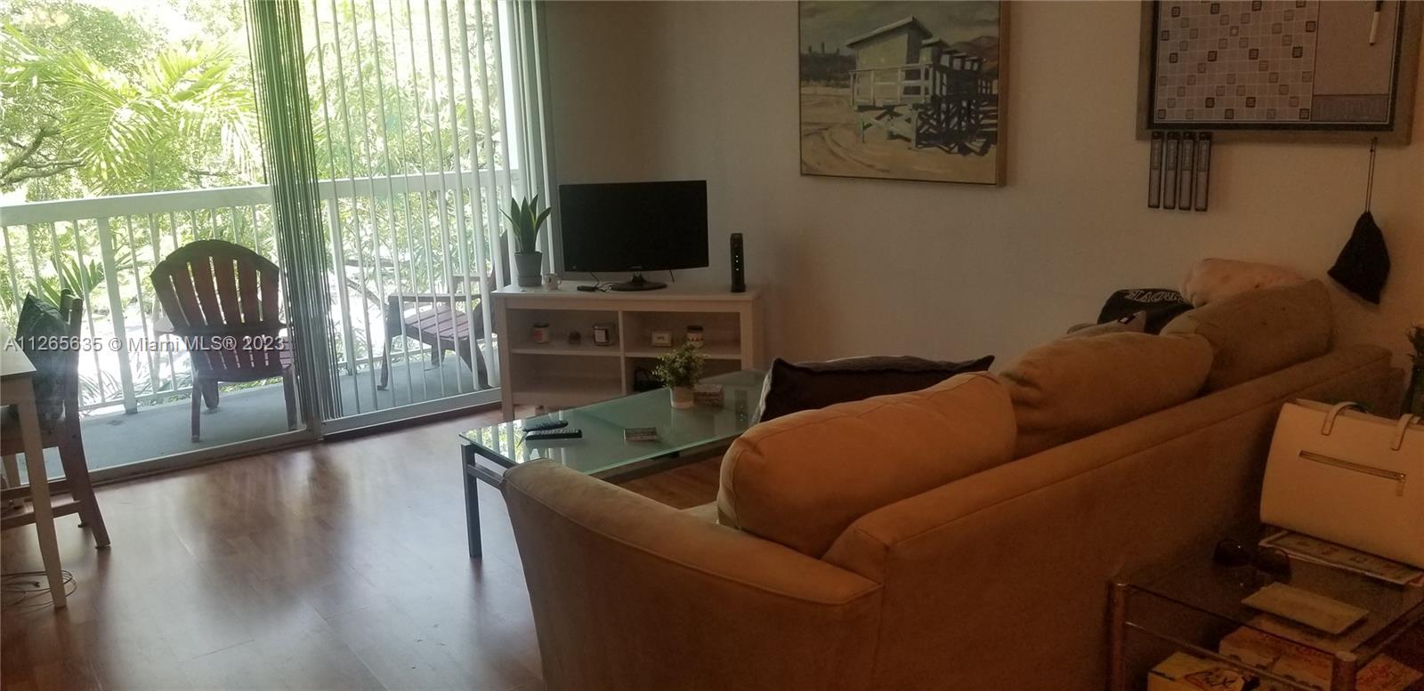 2920 Southwest 28th Terrace, Unit 304 Miami, FL 33133 - Photo 3 of 26 a living room with furniture and a flat screen tv