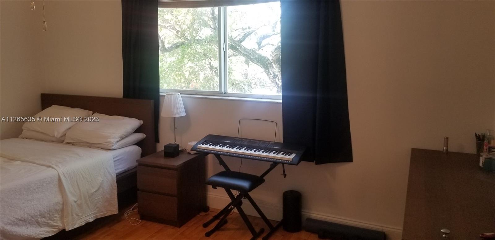 2920 Southwest 28th Terrace, Unit 304 Miami, FL 33133 - Photo 6 of 26 a bedroom with a bed and a window