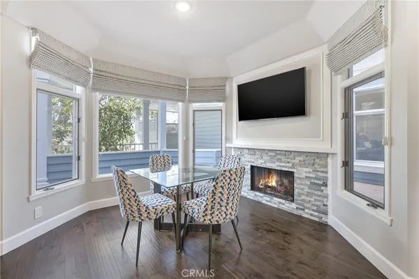 a dining room with furniture wooden floor a rug and a chandelier