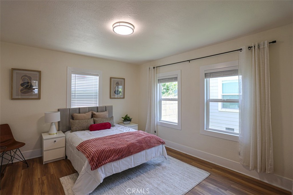 600 South Emily Street Anaheim, CA 92805 - Photo 13 of 22 a bedroom with a bed and wooden floor